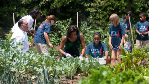 First lady says she is committed to giving kids the healthy futures they deserve. Here she works with chefs and students in the White House Kitchen Garden on the South Lawn in 2010. 