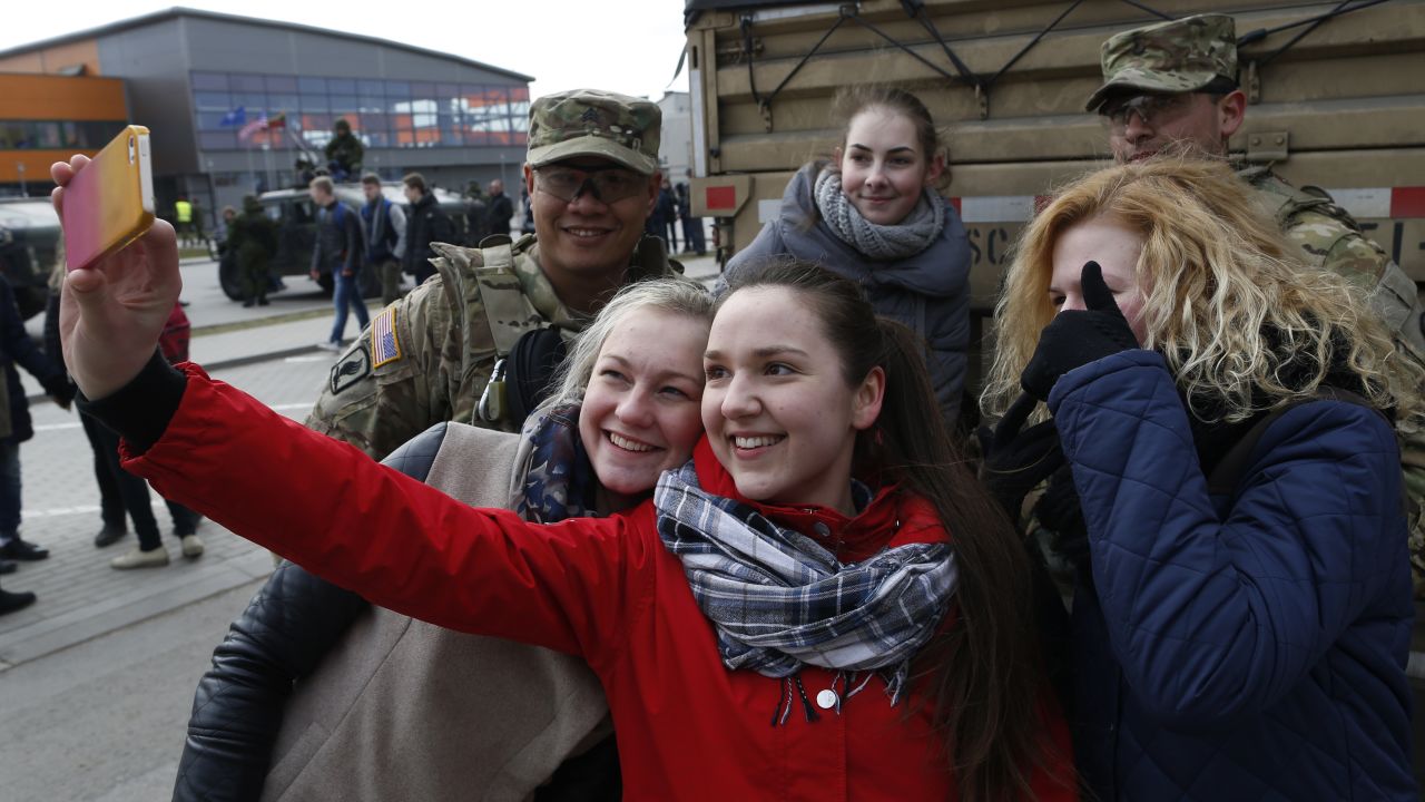 A girl takes a selfie with members of the 2nd Cavalry Regiment in Salociai on March 23.
