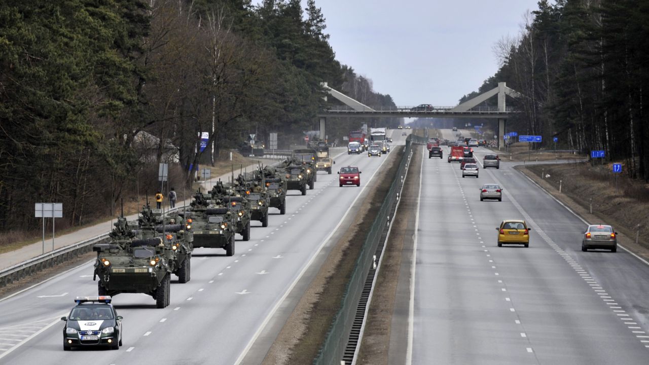 Stryker vehicles make their way down a highway in Riga, Latvia, on Sunday, March 22. The convoy is unusual because long-distance movement of heavy military vehicles such as the 18-ton Strykers is usually done by rail.