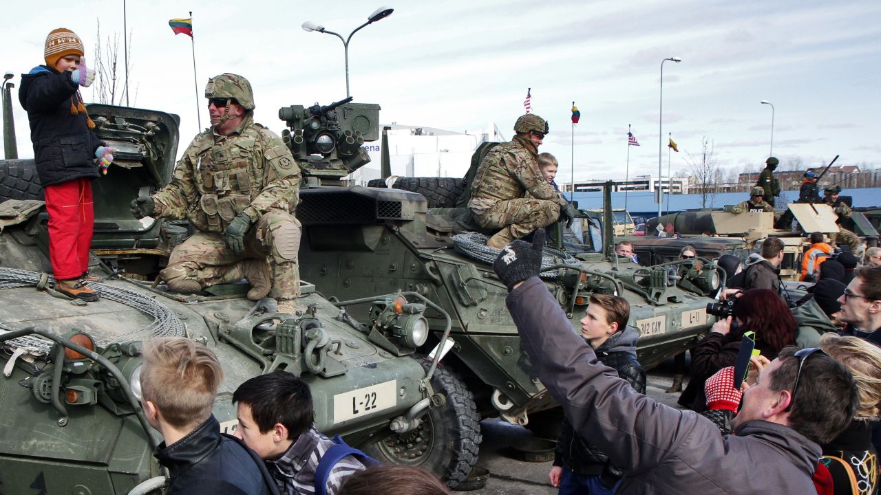 The soldiers meet with local residents in Vilnius on March 22.