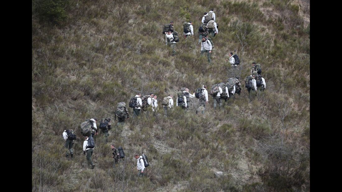 French military personnel move up a mountainside March 25 near Seyne-les-Alpes.