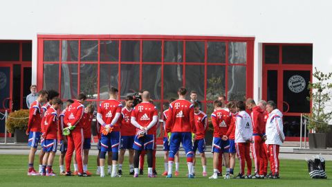 Members of the German soccer club Bayern Munich hold a moment of silence before their practice in Munich on March 25.