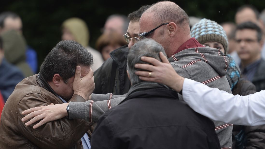Workers from the Delphi factory, who lost two colleagues in the crash, mourn together in Sant Cugat del Valles, Spain, on March 25.