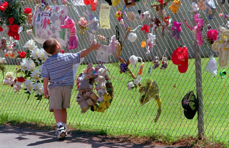 A boy visits the fence that surrounds the remains of the Federal Building in May 1997. It was later razed, and a park and memorial was built on the site.