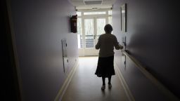 A woman, suffering from Alzheimer's desease, walks in a corridor on March 18, 2011 in a retirement house in Angervilliers, eastern France. AFP PHOTO / SEBASTIEN BOZON (Photo credit should read SEBASTIEN BOZON/AFP/Getty Images)
