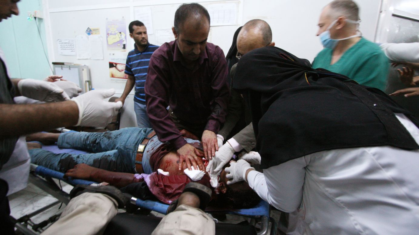 Medics treat an anti-Houthi protester who was injured during clashes with pro-Houthi police in Taiz on March 24.