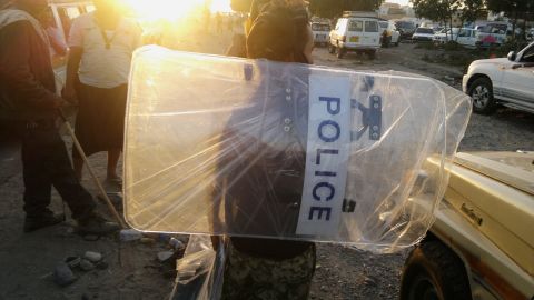 A man in Aden holds a police shield that he looted from a base belonging to forces loyal to Saleh on Thursday, March 19.