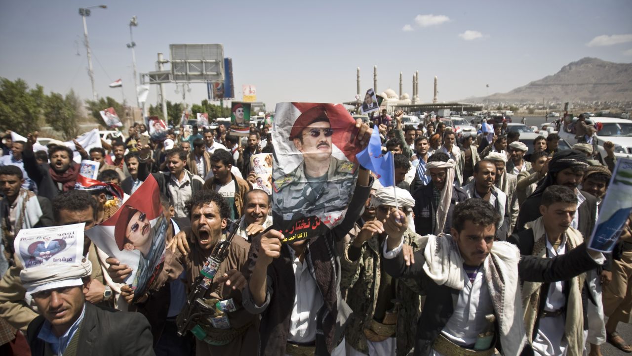 Supporters of Ahmed Ali Abdullah Saleh, the son of the former President, wave banners and shout slogans during a demonstration in Sanaa on Tuesday, March 10. The demonstrators were demanding presidential elections be held and that the younger Saleh run for office.
