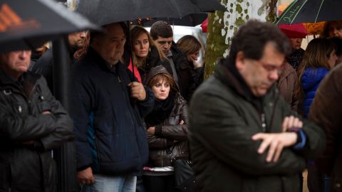 People pause for a moment of silence in Llinars del Valles, Spain, on Wednesday, March 25.