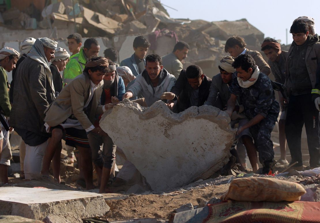 Yemeni civilians and security forces search for survivors in rubble after Saudi airstrikes against Houthi rebels near Sanaa Airport on March 26.