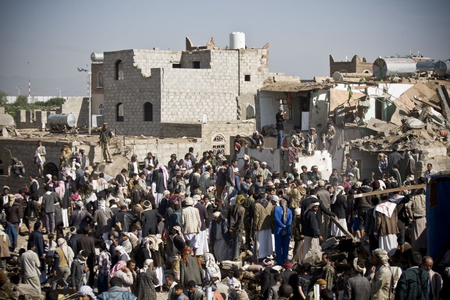 People search for survivors under the rubble of houses destroyed by airstrikes near the Sanaa Airport on March 26. 