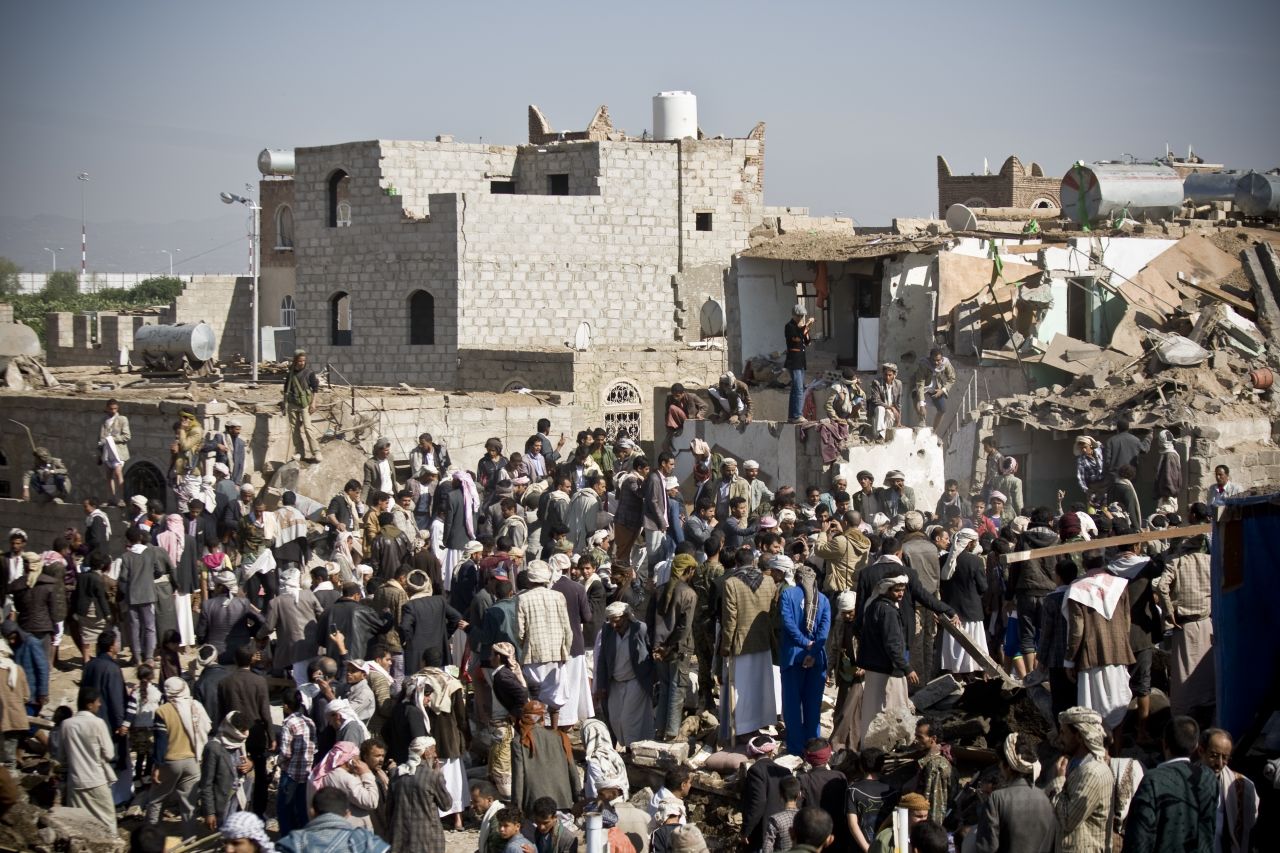 People search for survivors under the rubble of houses destroyed by airstrikes near the Sanaa Airport on March 26.
