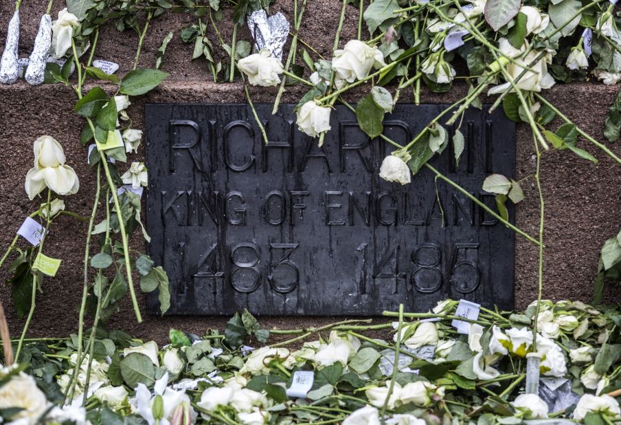 White roses adorn the statue of King Richard III before his remains were reburied Thursday, March 26, in Leicester, England. The medieval monarch's remains were found beneath a parking lot in 2012, 500 years after he was killed in the Battle of Bosworth Field.