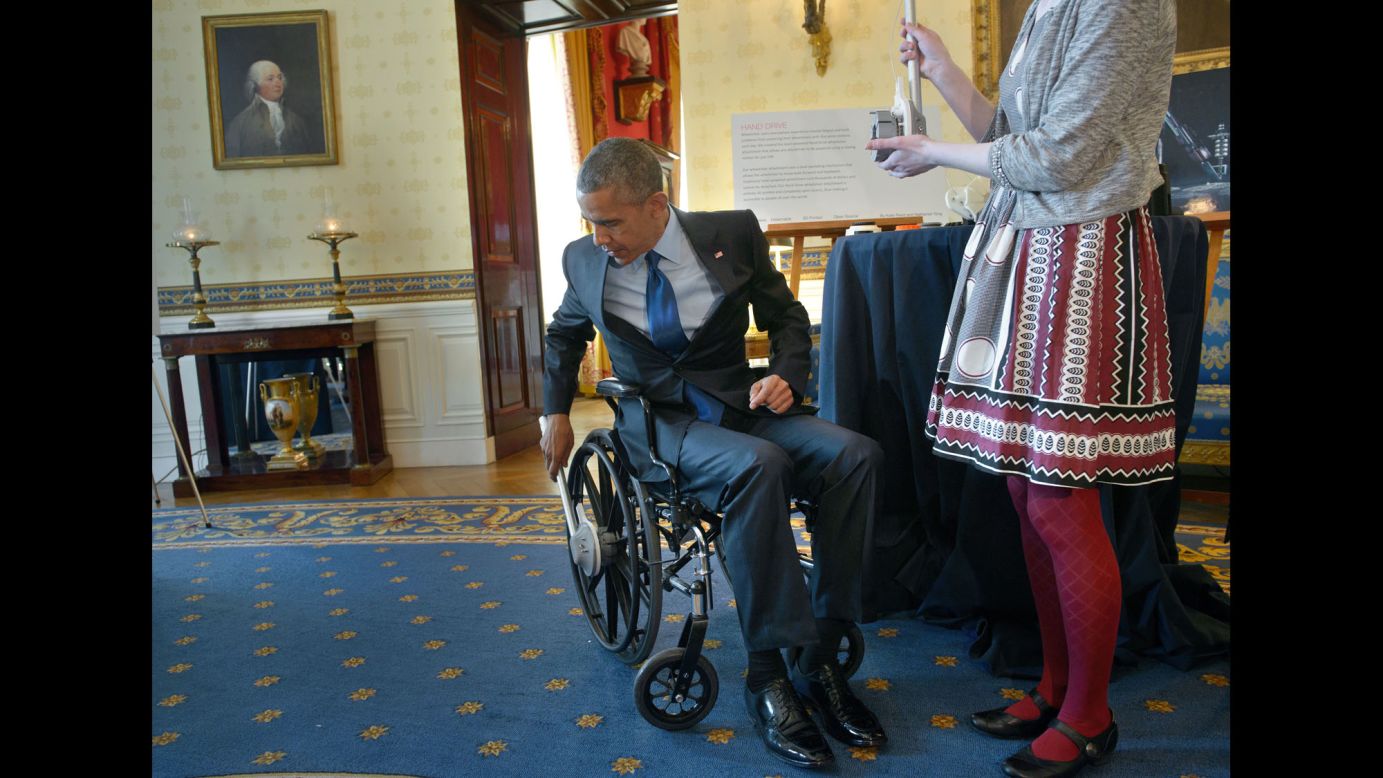 U.S. President Barack Obama tries a wheelchair designed by student Kaitlin Reed during the White House Science Fair on Monday, March 23. A rowing motion powers the wheelchair.
