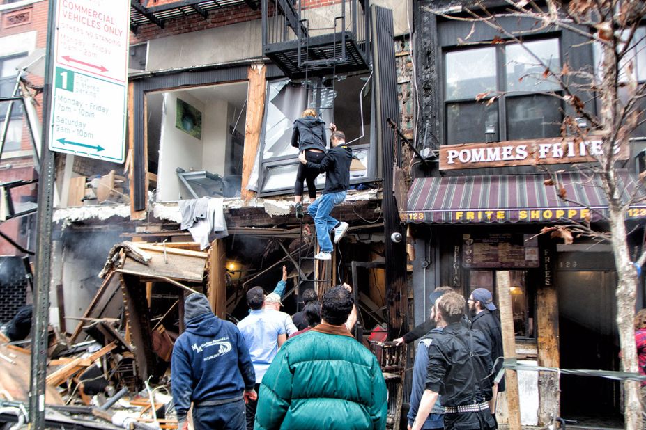 People climb down a fire escape at the scene of the explosion. Luca Babini, the iReporter who took this photo, said he was in his office less than a block away at the time of the blast. He said a man immediately climbed a fire escape in an attempt to rescue people. "I saw a lot of people lined up at the streets trying to help," he said.