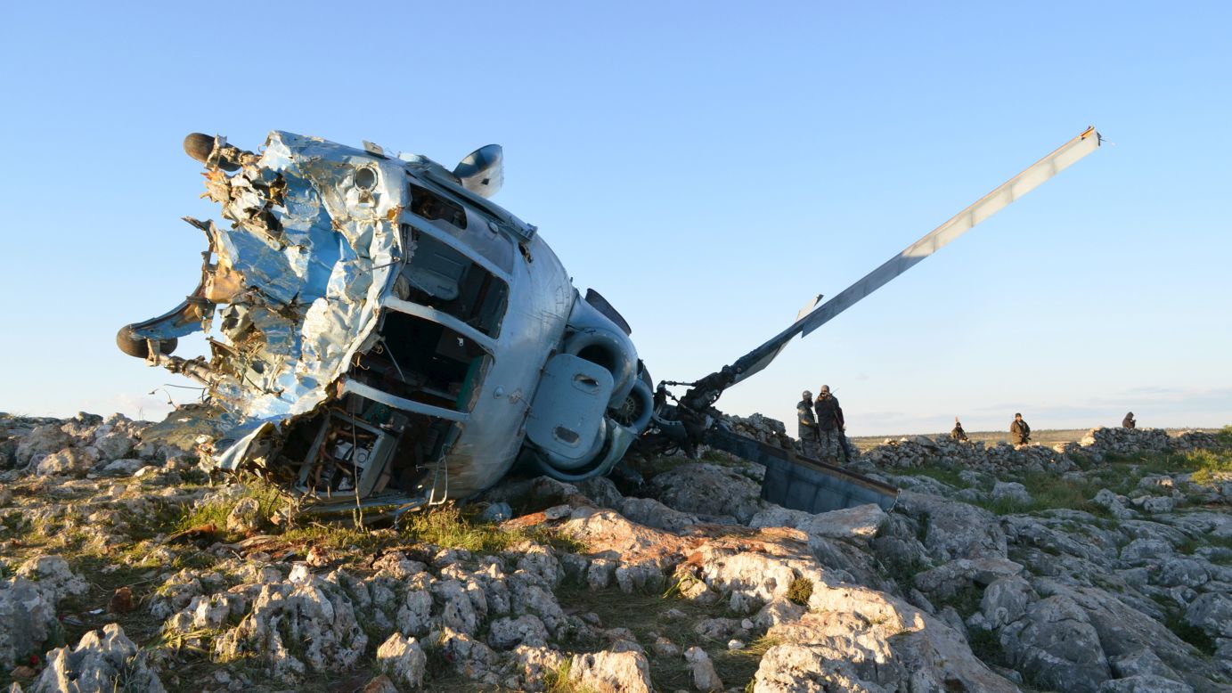Fighters with the Islamist militant group known as the al-Nusra Front inspect a Syrian military helicopter that crashed in Jabal al-Zawiya, Syria, on Sunday, March 22. 