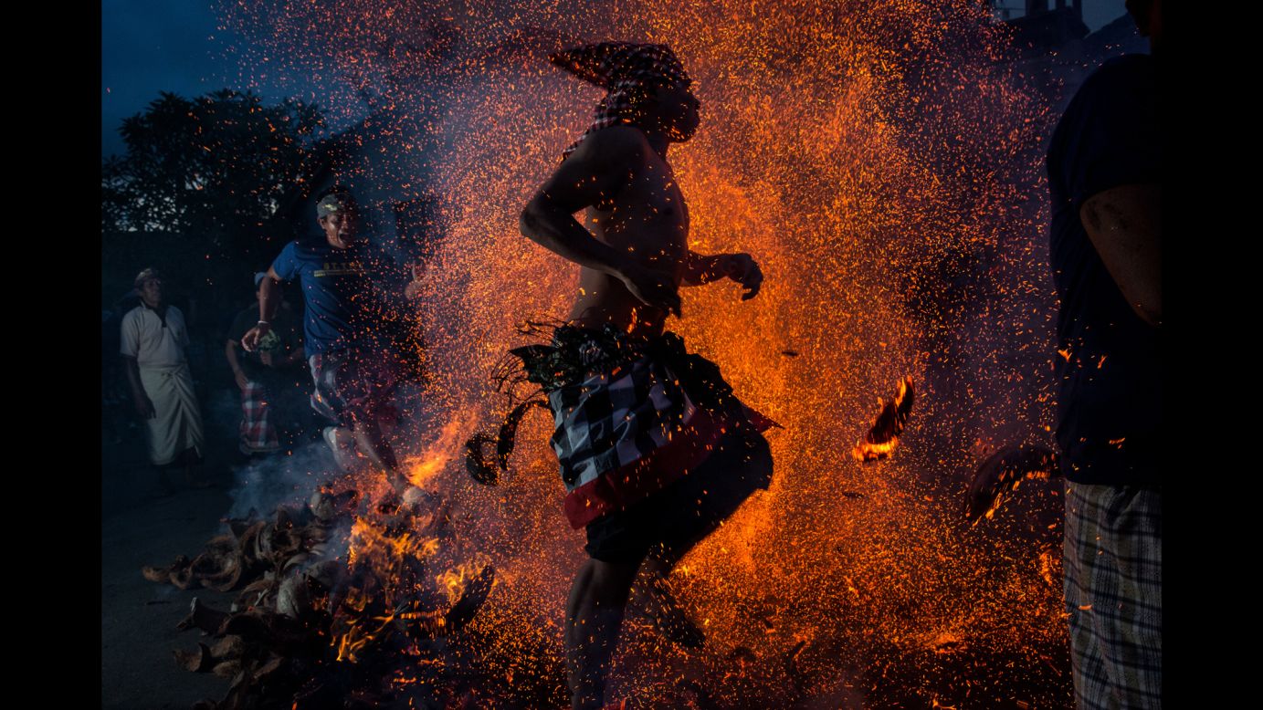 A Balinese man in Gianyar, Indonesia, kicks up the fire during the "Mesabatan Api" ritual ahead of the Nyepi Day of Silence on Friday, March 20. Nyepi is a Hindu celebration observed every New Year according to the Balinese calendar. The national holiday is one of self-reflection and meditation, and activities such as working, watching television and traveling are restricted between the hours of 6 a.m. and 6 p.m. 
