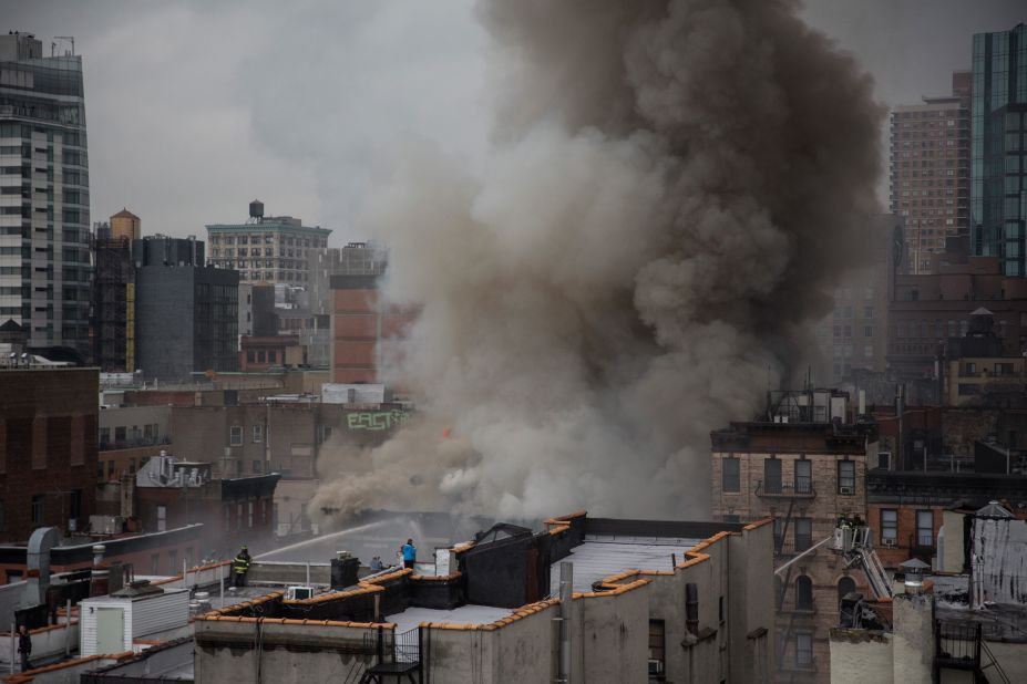 Smoke obscures the New York skyline as firefighters battle the blaze. 