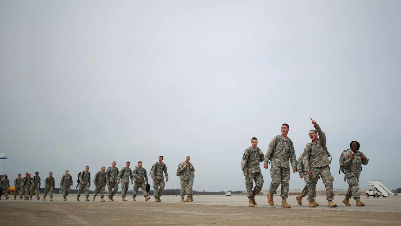Soldiers from the U.S. Army's 101st Airborne Division walk across the tarmac at Campbell Army Airfield before reuniting with their families at a homecoming ceremony Saturday, March 21, in Fort Campbell, Kentucky. The 162 soldiers were deployed in Liberia, where they helped fight the spread of Ebola.