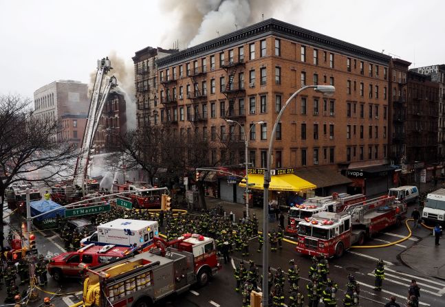 The collapsed first floor appeared to house a Japanese restaurant; the building next door, with a shop specializing in French fries on the street level, was ablaze and appeared to have collapsed.