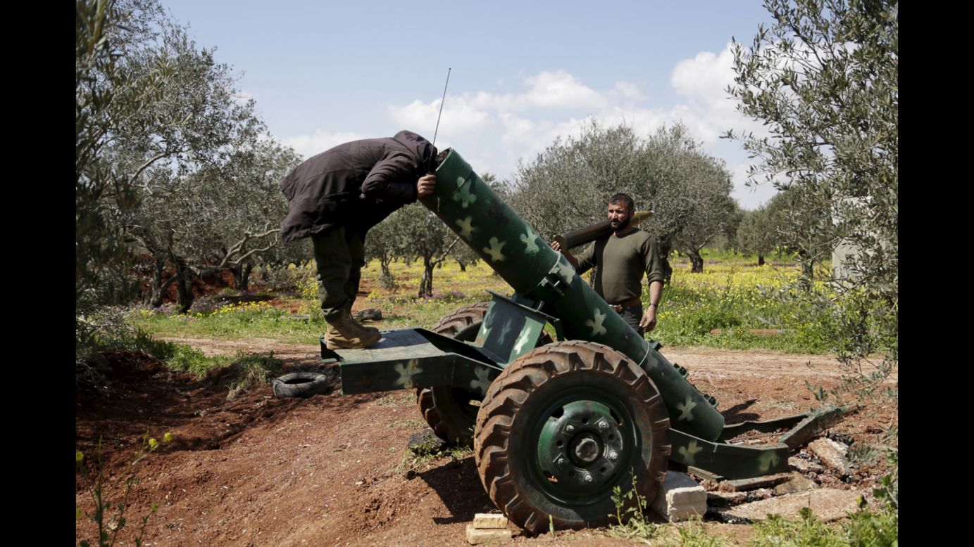 A Syrian rebel looks inside a cannon in Idlib, Syria, on Monday, March 23.