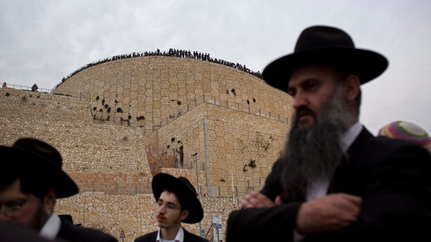 Jewish men in Jerusalem attend a funeral Monday, March 23, for seven children who were killed in a New York house fire. The bodies of the seven Jewish siblings, ages 5 to 16, were flown to Israel overnight and taken to Jerusalem in a convoy escorted by police.
