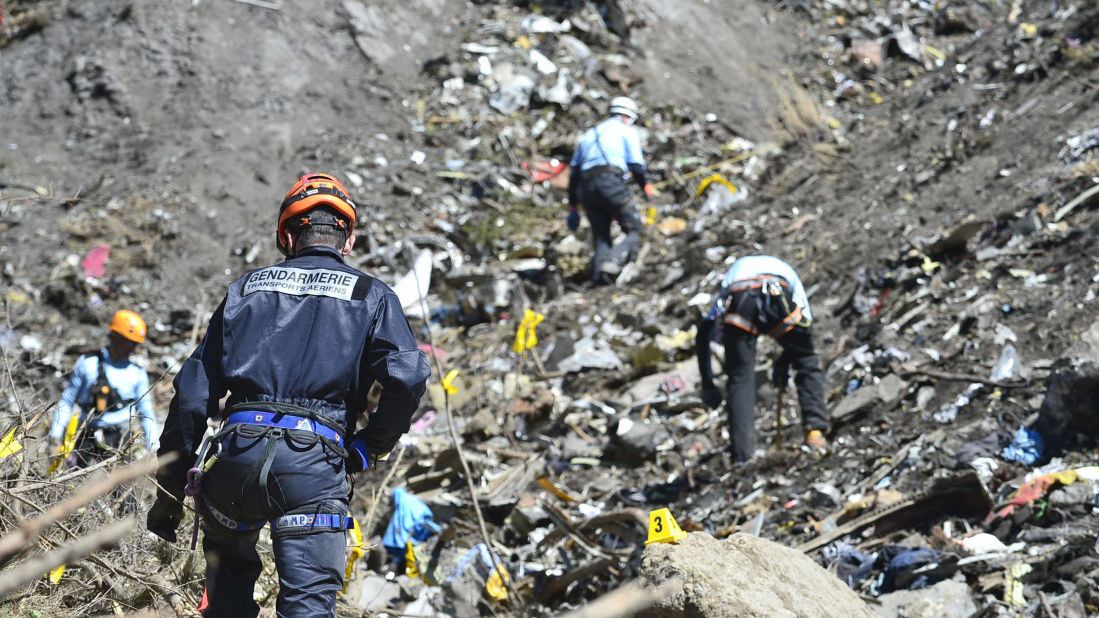 Rescue workers continue to search the site of the crash on March 26.