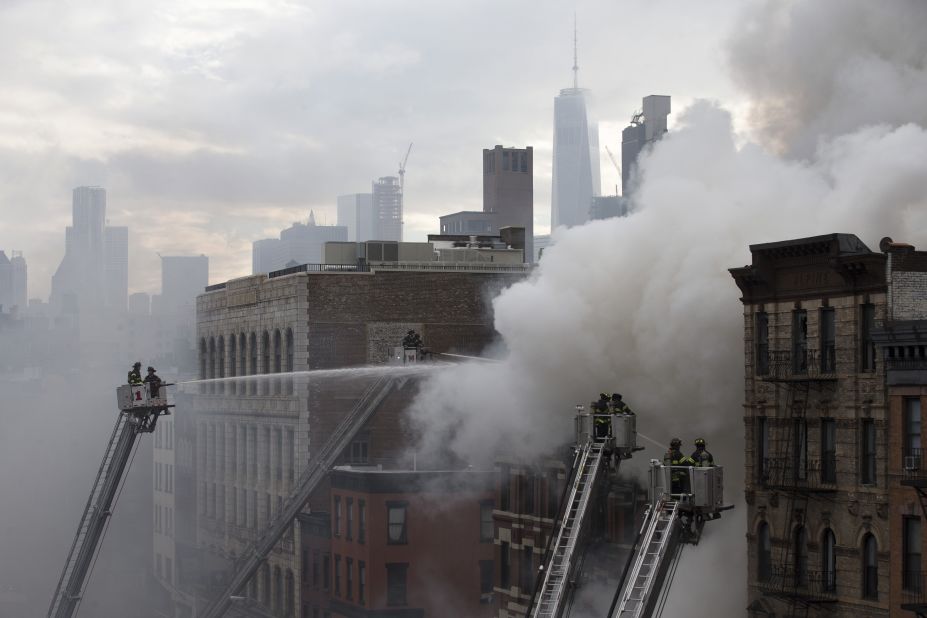 Firefighters work the scene of a burning building after an explosion on March 26 on New York City's Second Avenue. 