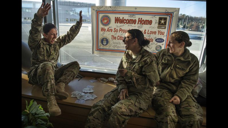 U.S. Navy Lt. Jaclyn Trosper celebrates after winning a card game on February 17, 2014, while awaiting deployment to Afghanistan. 