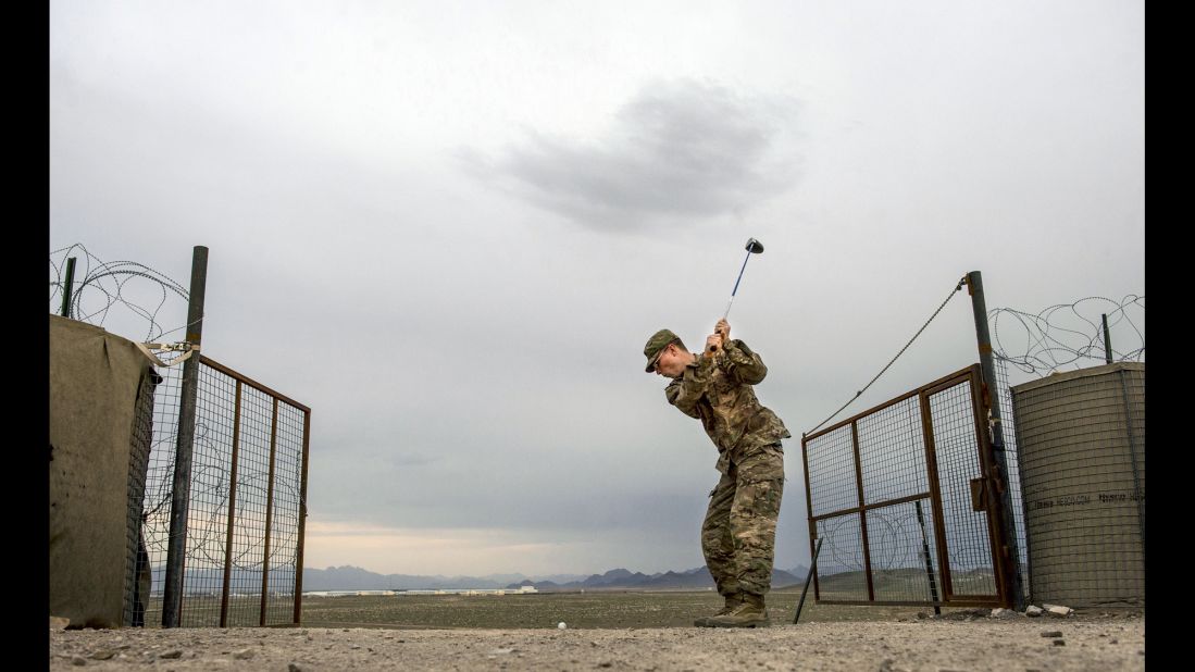 An off-duty U.S. Army soldier hits golf balls in Afghanistan on March 29, 2014. Military members try to  maintain a healthy balance of physical and social activities during their deployments. 