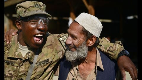 U.S. Army Staff Sgt. Damion Kennedy shares a laugh with an Afghan man as he helps oversee a base detail project April 8, 2014, in Afghanistan. Kennedy and many of his fellow soldiers developed strong connections with Afghans during their deployment.