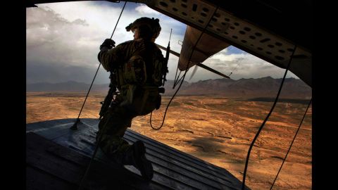U.S. Air Force Tech. Sgt. Josh Martin, an aerial gunner with the 438th Air Expeditionary Advisory Squadron, provides rear security on a Mi-17 helicopter in Kabul, Afghanistan, on May 31, 2014. The squadron and the Afghan air force have combined training efforts to help Afghan helicopter crews work seamlessly in support of ground forces in combat.