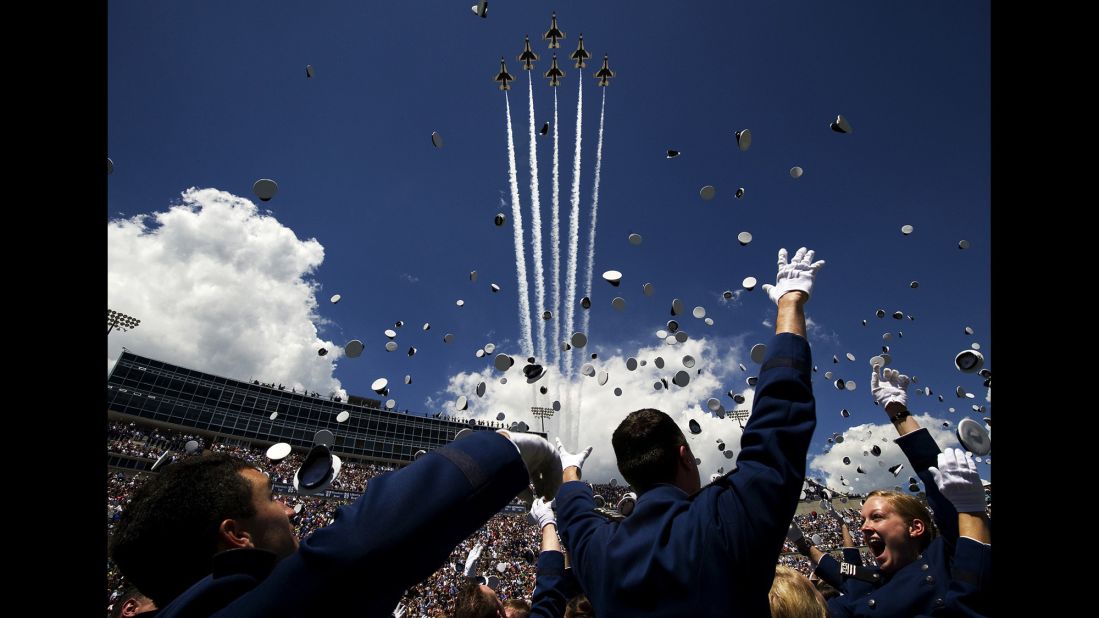 Air Force cadets toss their caps in the air as U.S. Air Force Thunderbirds fly in Delta formation overhead during the U.S. Air Force Academy's graduation ceremony May 28, 2014, in Colorado Springs, Colorado. 