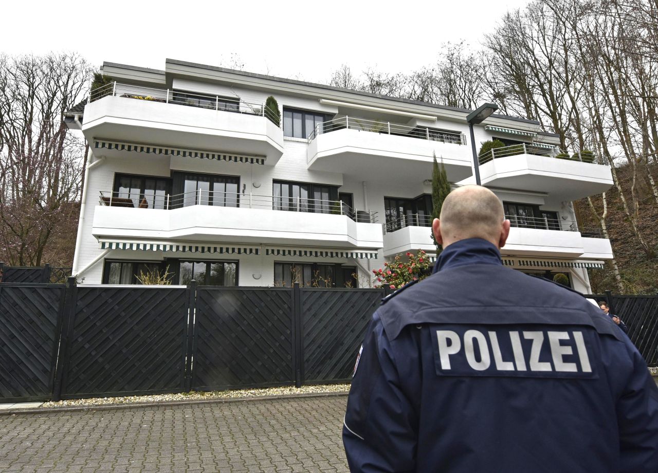 A police officer stands guard March 26 at an apartment building where Lubitz was thought to have lived in Dusseldorf.