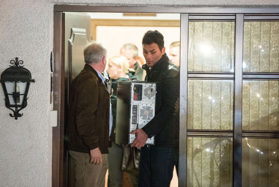 Investigators carry a computer from the home of Lubitz's parents in Montabaur, Germany, on Thursday, March 26.