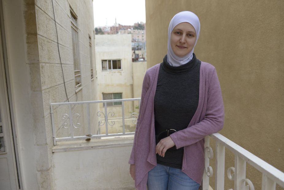 Hiba, 26, outside the apartment building where she and her parents are staying in a north Amman suburb. Four years ago, Hiba was sitting for exams at university when planes began dropping bombs near her home.  She and her parents were forced to seek refuge in Jordan.