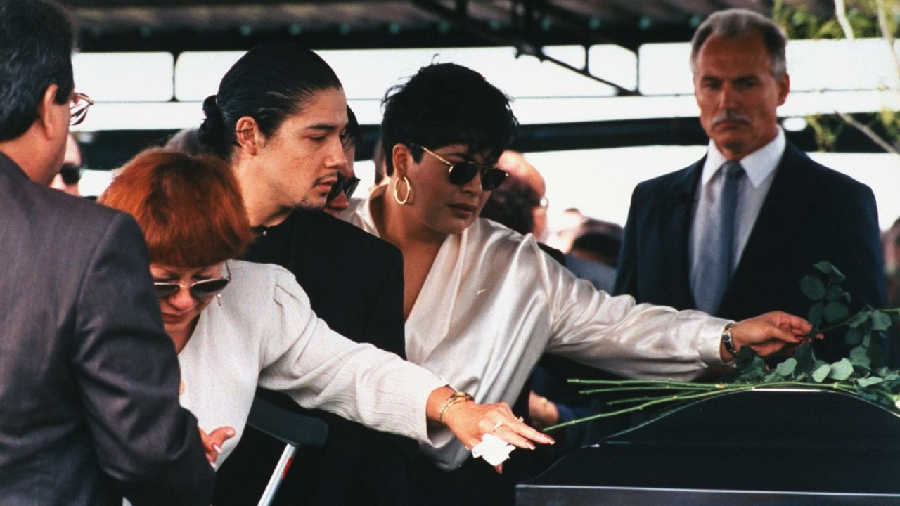 Selena's mother, Marcela Quintanilla; husband, Chris Perez; and sister, Suzette, lay roses on her casket at her funeral.