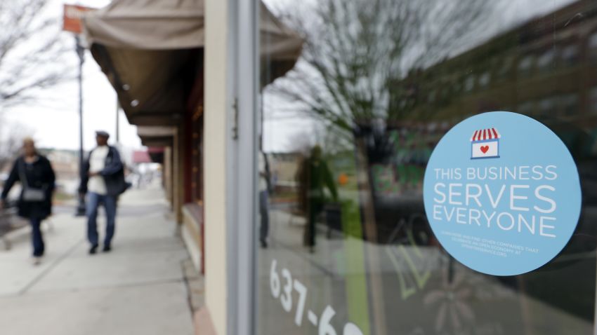 A window sticker on a downtown Indianapolis florist, Wednesday, March 25, 2015, shows it's objection to the Religious Freedom bill passed by the Indiana legislature. Organizers of a major gamers' convention and a large church gathering say they're considering moving events from Indianapolis over a bill that critics say could legalize discrimination against gays. (AP Photo/Michael Conroy)