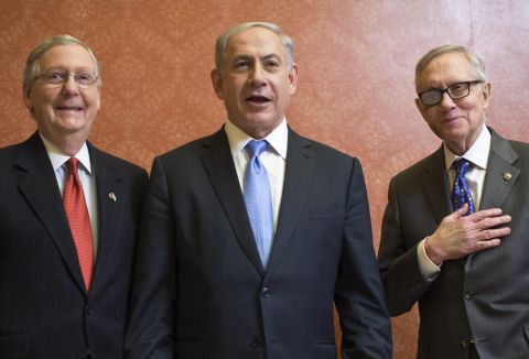 McConnell and Reid pose with Israel's Prime Minister Benjamin Netanyahu ahead of a meeting on Capitol Hill on March 3.