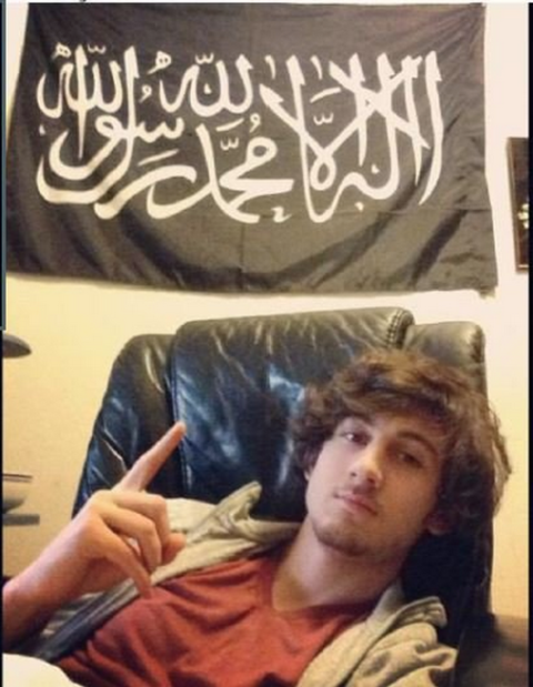 Tsarnaev poses in front of a black standard adopted by various militant Islamist groups in this Instagram photo that was entered as evidence.