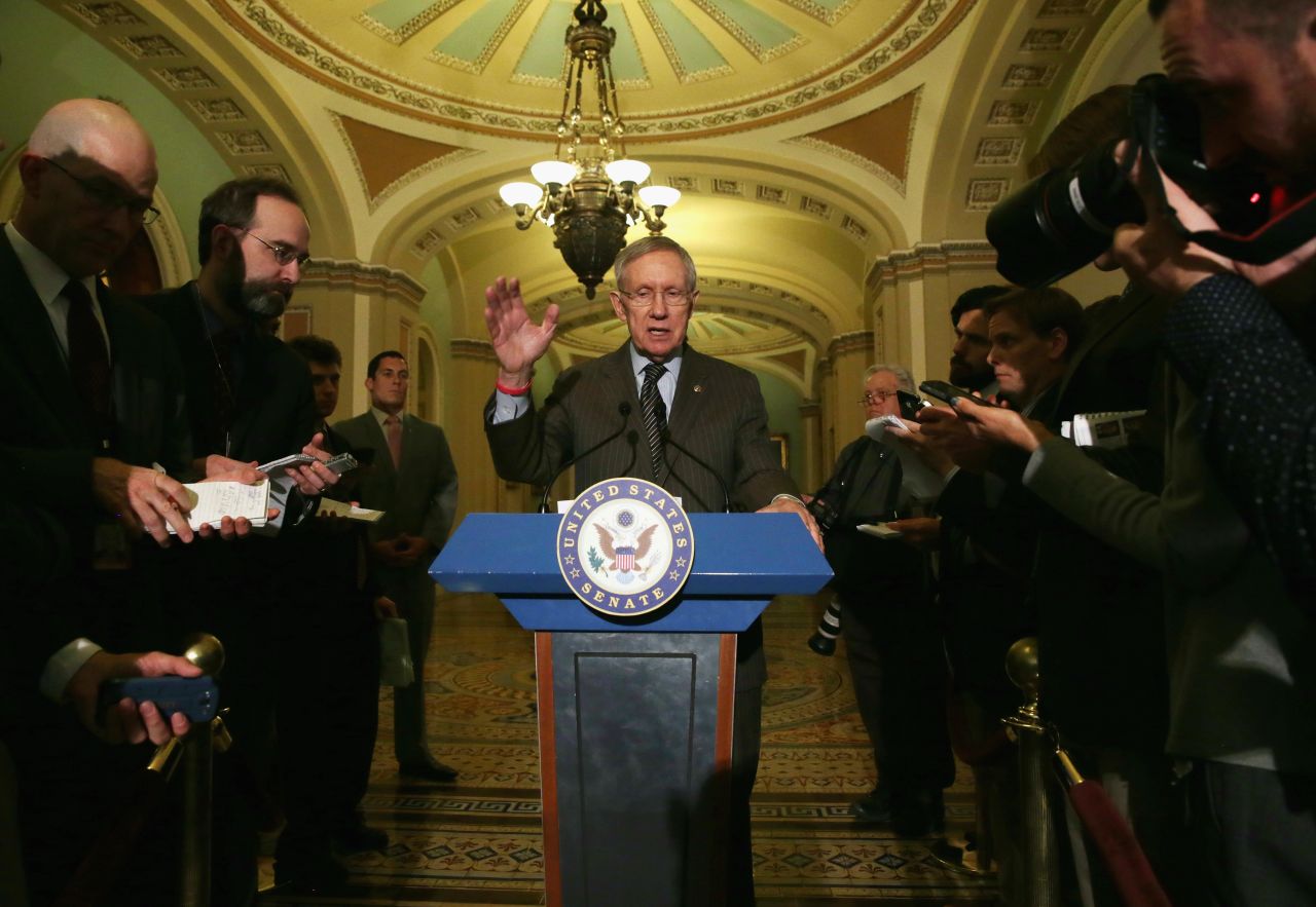 Reid speaks to members of the media after a policy luncheon May 6, 2014 on Capitol Hill.