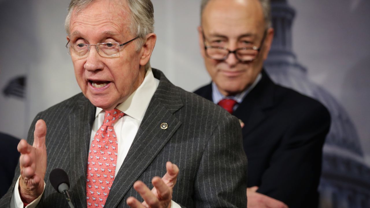 U.S. Senate Majority Leader Sen. Harry Reid (D-NV) (left) speaks as Sen. Charles Schumer (D-NY) (right) listens during a news conference March 26, 2014 on Capitol Hill in Washington, D.C.
