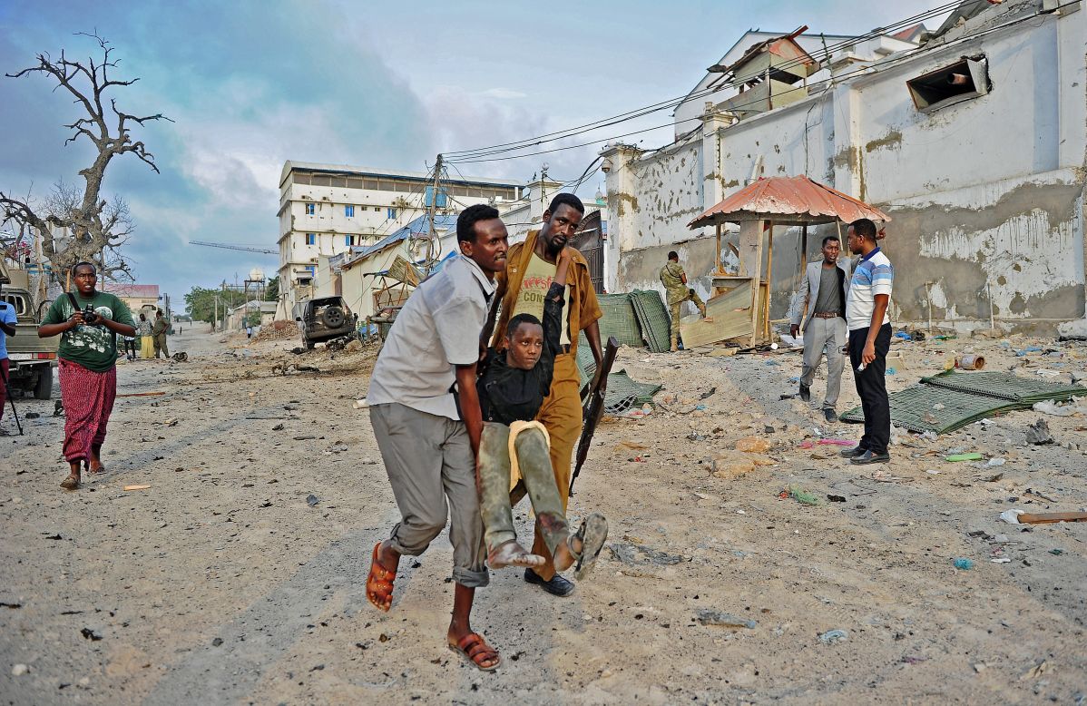 An injured youth is carried away from the scene of the attack. 