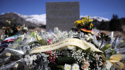 A stele and flowers laid in memory of the victims are placed in the area where the Germanwings jetliner crashed in the French Alps, in Le Vernet, France, Friday, March 27, 2015. The crash of Germanwings Flight 9525 into an Alpine mountain, which killed all 150 people aboard, has raised questions about the mental state of the co-pilot. Authorities believe the 27-year-old German deliberately sought to destroy the Airbus A320 as it flew Tuesday from Barcelona to Duesseldorf. (AP Photo/Christophe Ena)