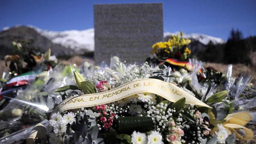 A stele and flowers laid in memory of the victims are placed in the area where the Germanwings jetliner crashed in the French Alps, in  Le Vernet, France, Friday, March 27, 2015. The crash of Germanwings Flight 9525 into an Alpine mountain, which killed all 150 people aboard, has raised questions about the mental state of the co-pilot. Authorities believe the 27-year-old German deliberately sought to destroy the Airbus A320 as it flew Tuesday from Barcelona to Duesseldorf. (AP Photo/Christophe Ena)