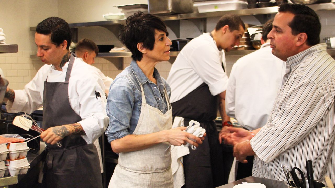Crenn consults with trusted mushroom supplier Antoine Magnani in the bustling Atelier Crenn kitchen.