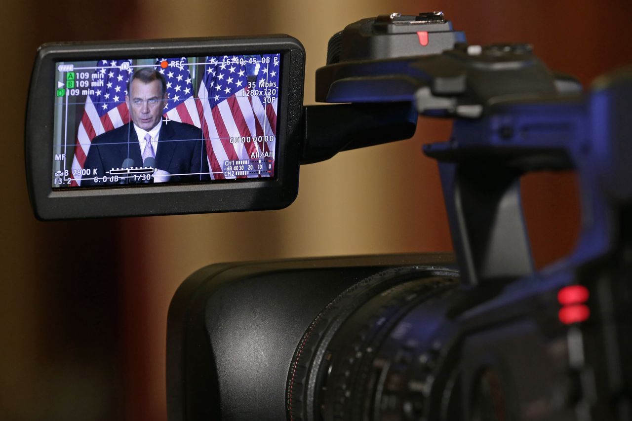 The image of the Speaker of the House John Boehner (R-OH) is displayed in a monitor of a camera as he talks with reporters in his office in the Capitol in November 2014 in Washington. 