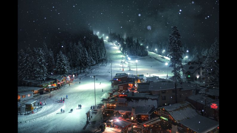 <strong>"Winter dream" by Yasen Georgiev</strong><br />Photographer's description: The image was taken in March of 2014. I was on a skiing holiday with friends in Borovets, which is one of the most famous ski resorts in Bulgaria. The last night before we left, I was looking out of my hotel room and dreaming of staying few more days. It was such a calm atmosphere, and I decided to take a final picture before I had to go. I wanted to catch the snow and bring atmosphere to the photo, so I turned the flash on. That's how I made this amazing landscape, which truly illustrates my winter dream.