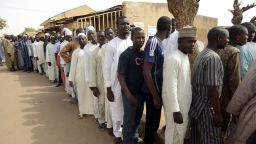 Men wait in line on March 28, 2015 outside a polling station in Gidan Niyam Sakin Yara in Daura in Katsina State. Polling stations opened in Nigeria on March 28, the electoral commission said, as voters went to the polls to elect a new president in what is being seen as the closest campaign in the country's history.