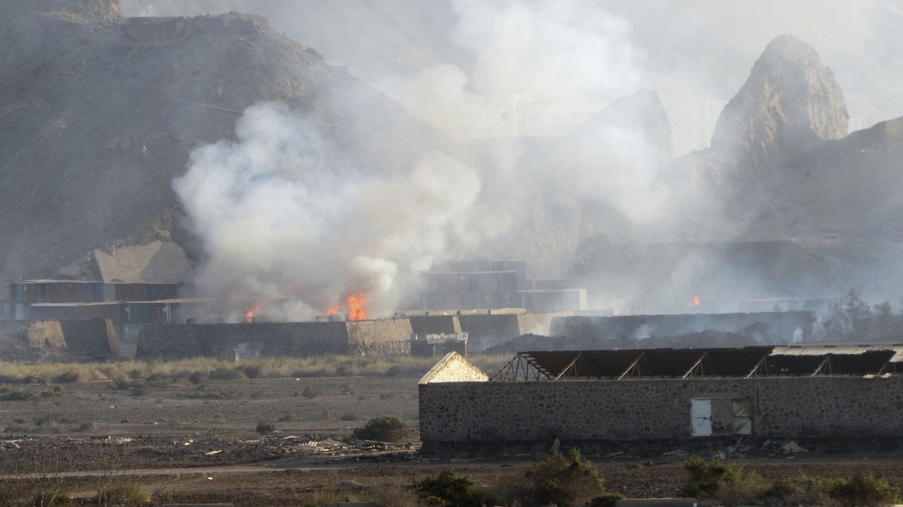 Buildings burn at the Jabal al-Hadid military camp in Aden on Saturday, March 28. Yemeni military officials said an explosion rocked the camp that houses a weapons depot, killing and wounding several people. The camp reportedly had been taken by security forces loyal to former Yemeni President Ali Abdullah Saleh. Some of the forces aligned with the Houthis are also loyal to Saleh, who resigned in 2012 after months of Arab Spring protests.